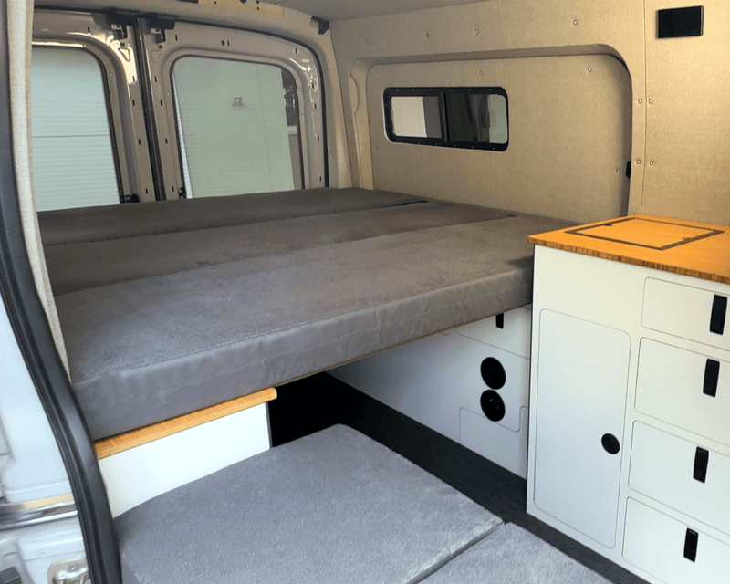 Load image into Gallery viewer, FlexDeck modular van bed system installed between wheel well cabinets